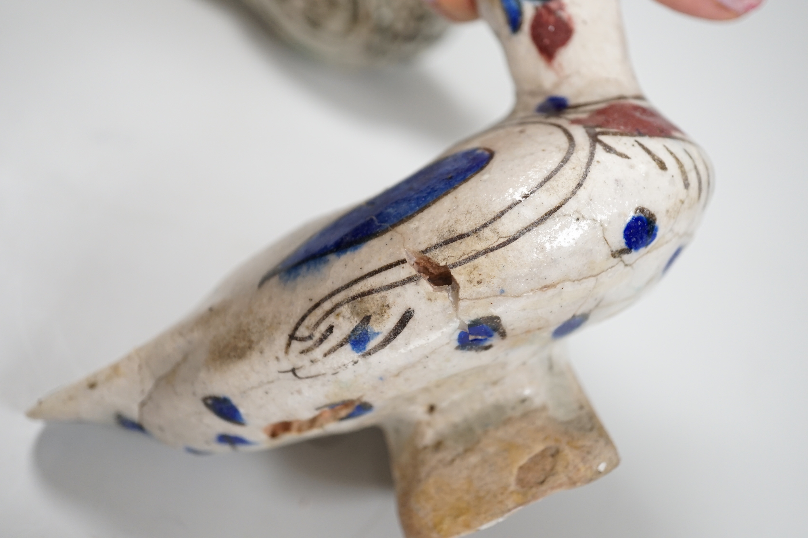 Three Persian tin glazed fritware Islamic birds, tallest 11cm